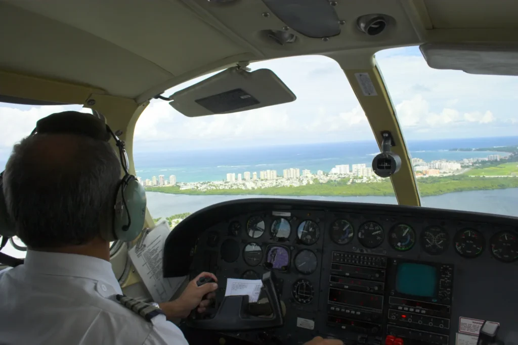 Pilot using outside visual references for VFR navigation during coastal flight in a light aircraft